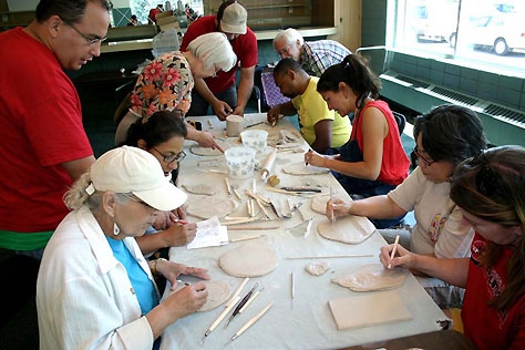 Community members create handmade ceramic tiles in a neighborhood artist’s studio for the  Living 2007  bricolage.