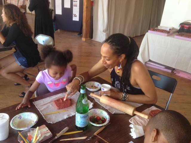 Artist Sonja Henderson assists community members in the creation of tiles for the MLK Living Memorial.