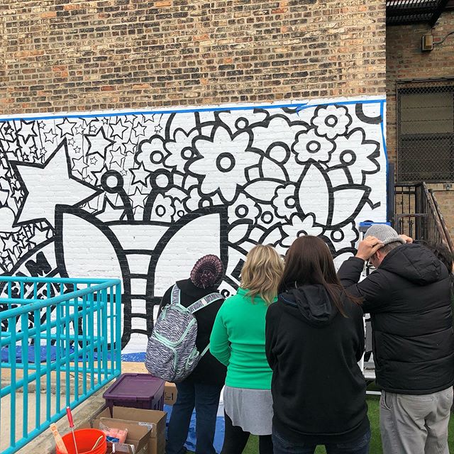 Motorola Solutions team painting mural on the Sidney Epstein Youth Center wall, lead by artist Delilah Salgado. #communitypublicart #chicagopublicartgroup #chicagoyouthcenters #mural #motorolasolutions