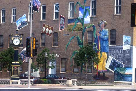 Its Merits Recommend It: the DeKalb Community Mural,  1999, acrylic paint on brick, by Olivia Gude.